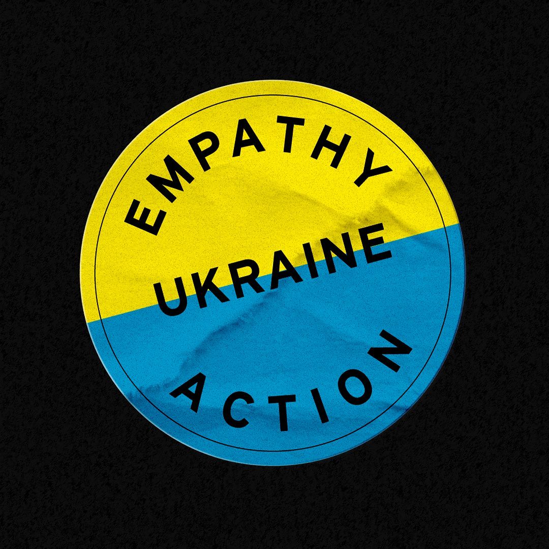 a half blue half yellow sticker reading empathy, ukraine, action